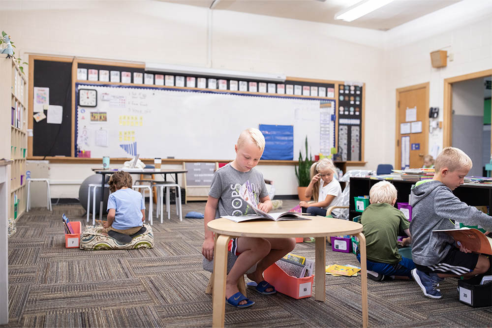 Little boy reading at a table at Hudsonville Christian School