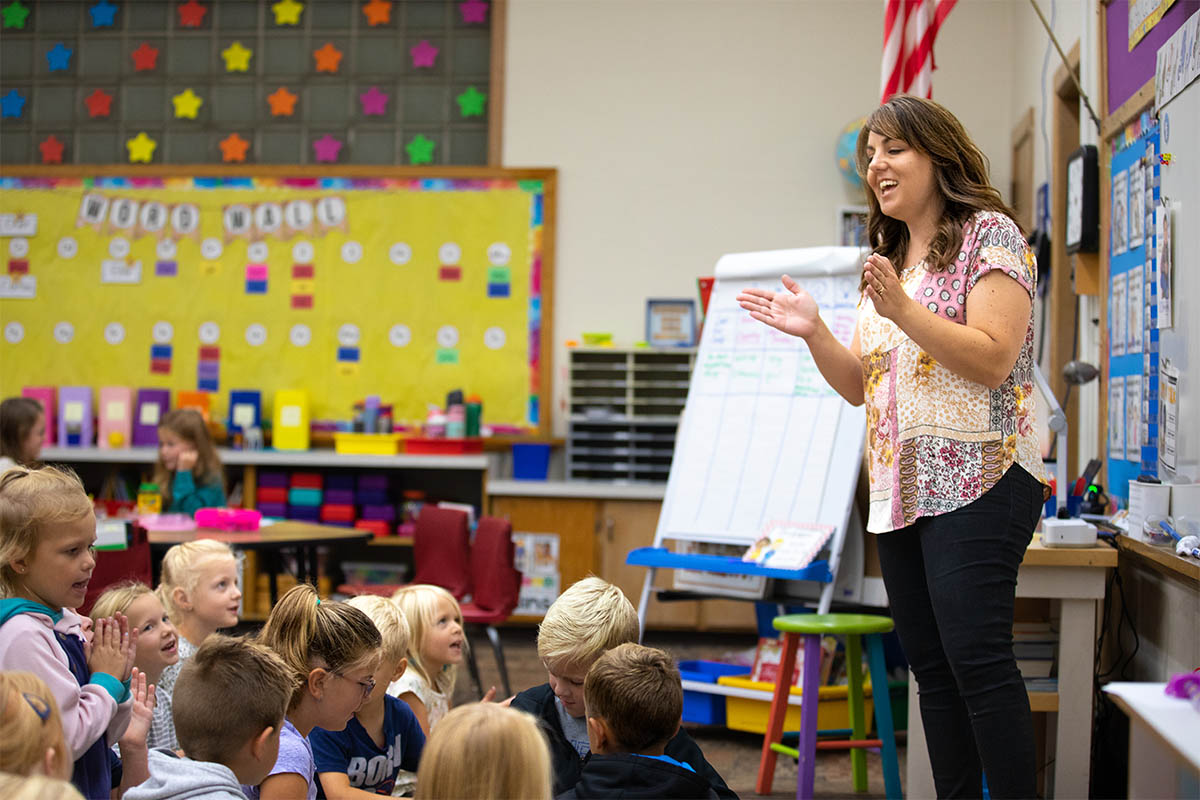 Kindergarten teacher leading a song at HCS.